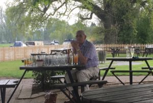 Chap with a drinking problem on the adjacent table